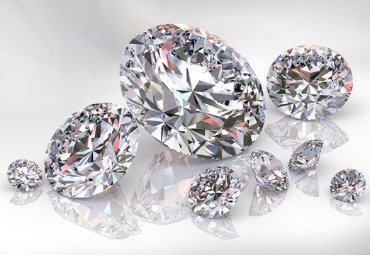 A brown diamond is sitting on top of a white cushion.
