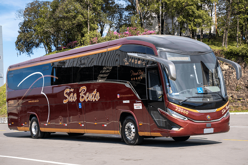 Um ônibus azul e verde na rodoviária com a palavra sul minas na lateral