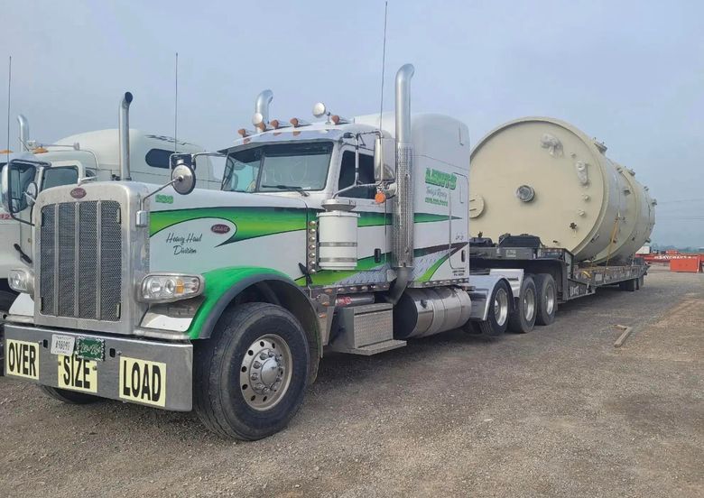 A semi truck with a large tank on the back of it