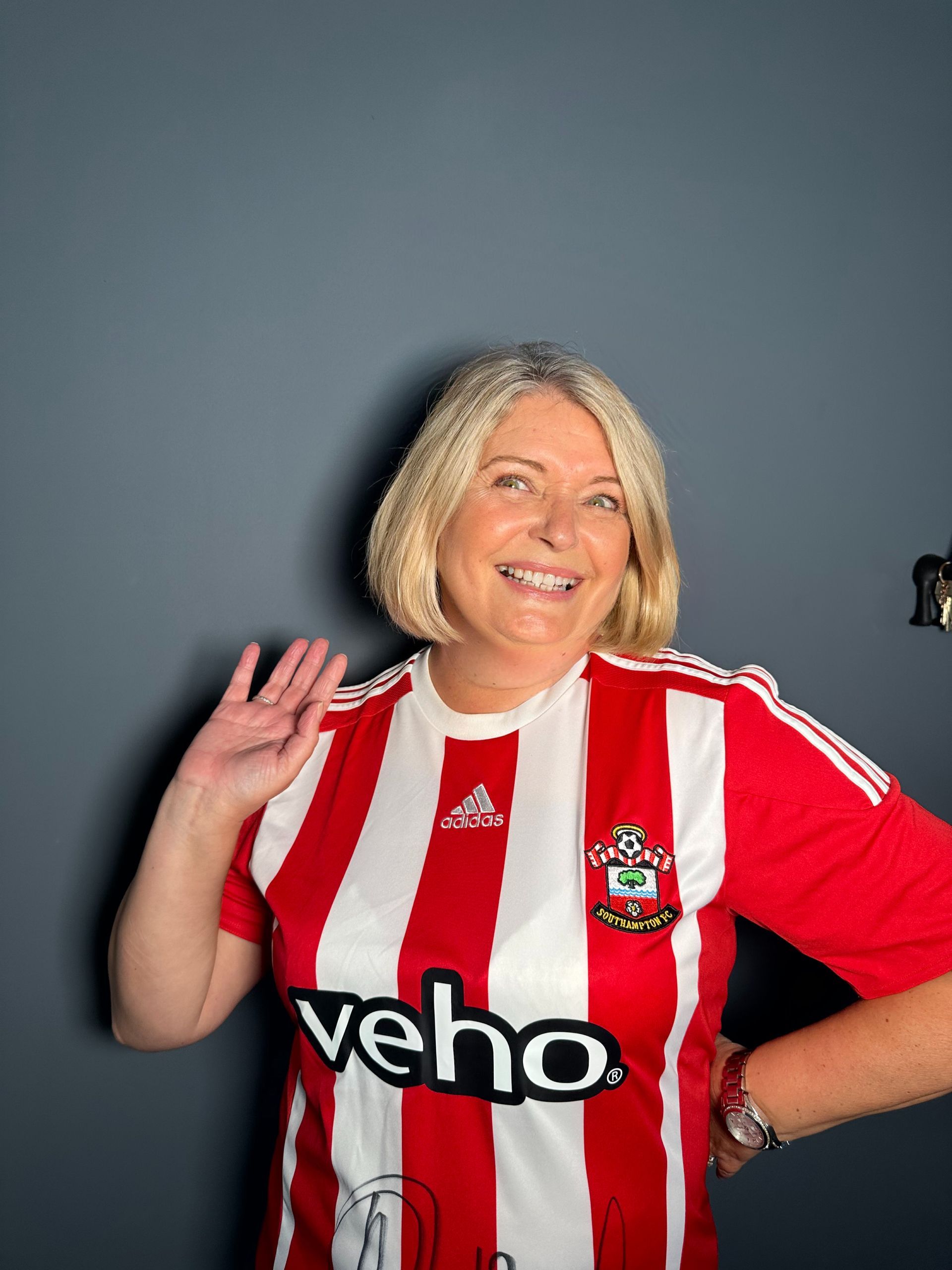 A woman wearing a red and white striped shirt with the word veho on it