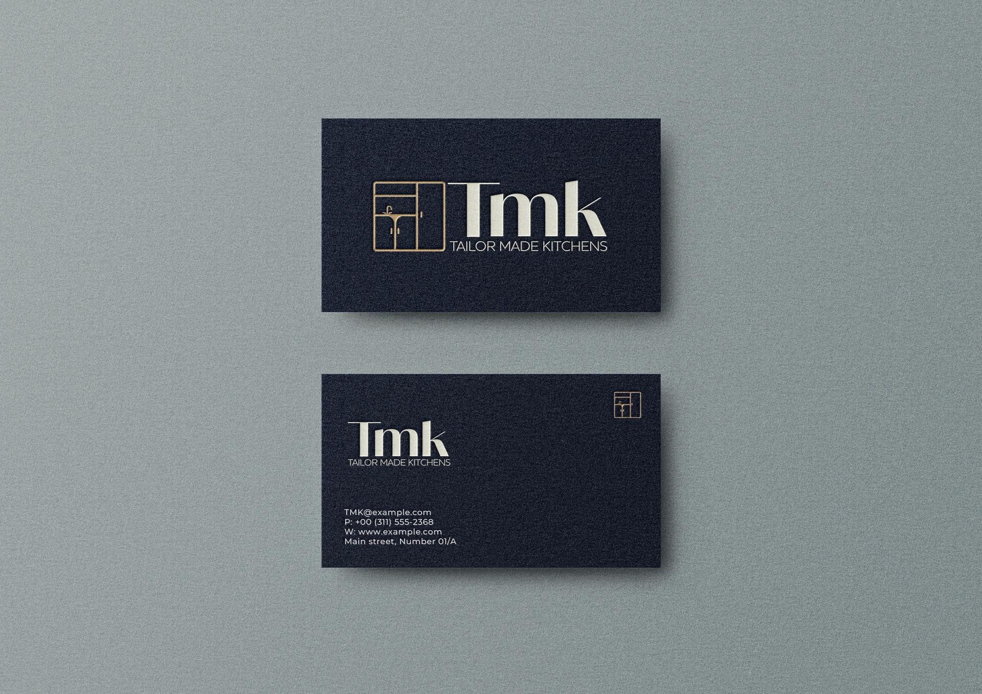 Two business cards are sitting on top of each other on a gray surface.