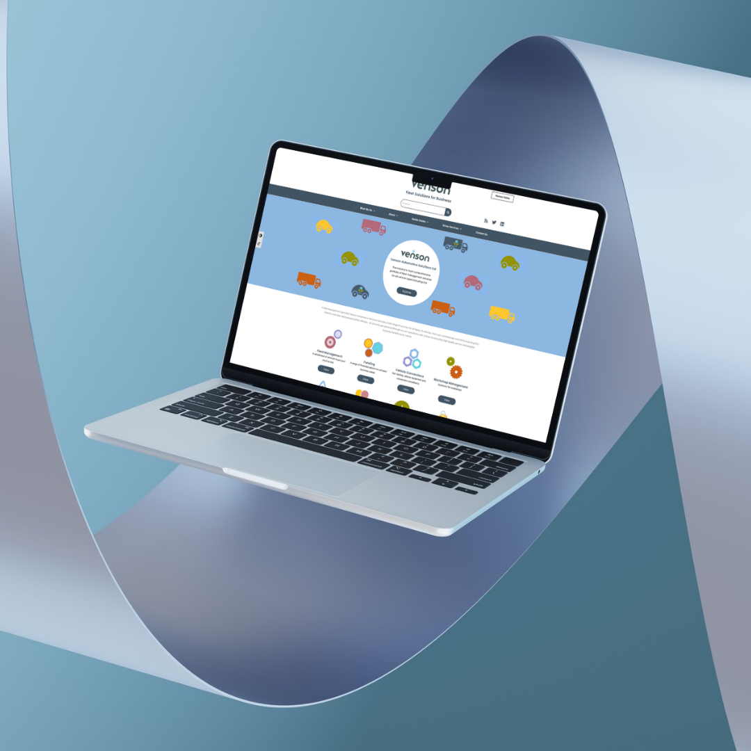 A laptop computer is sitting on a piece of paper.