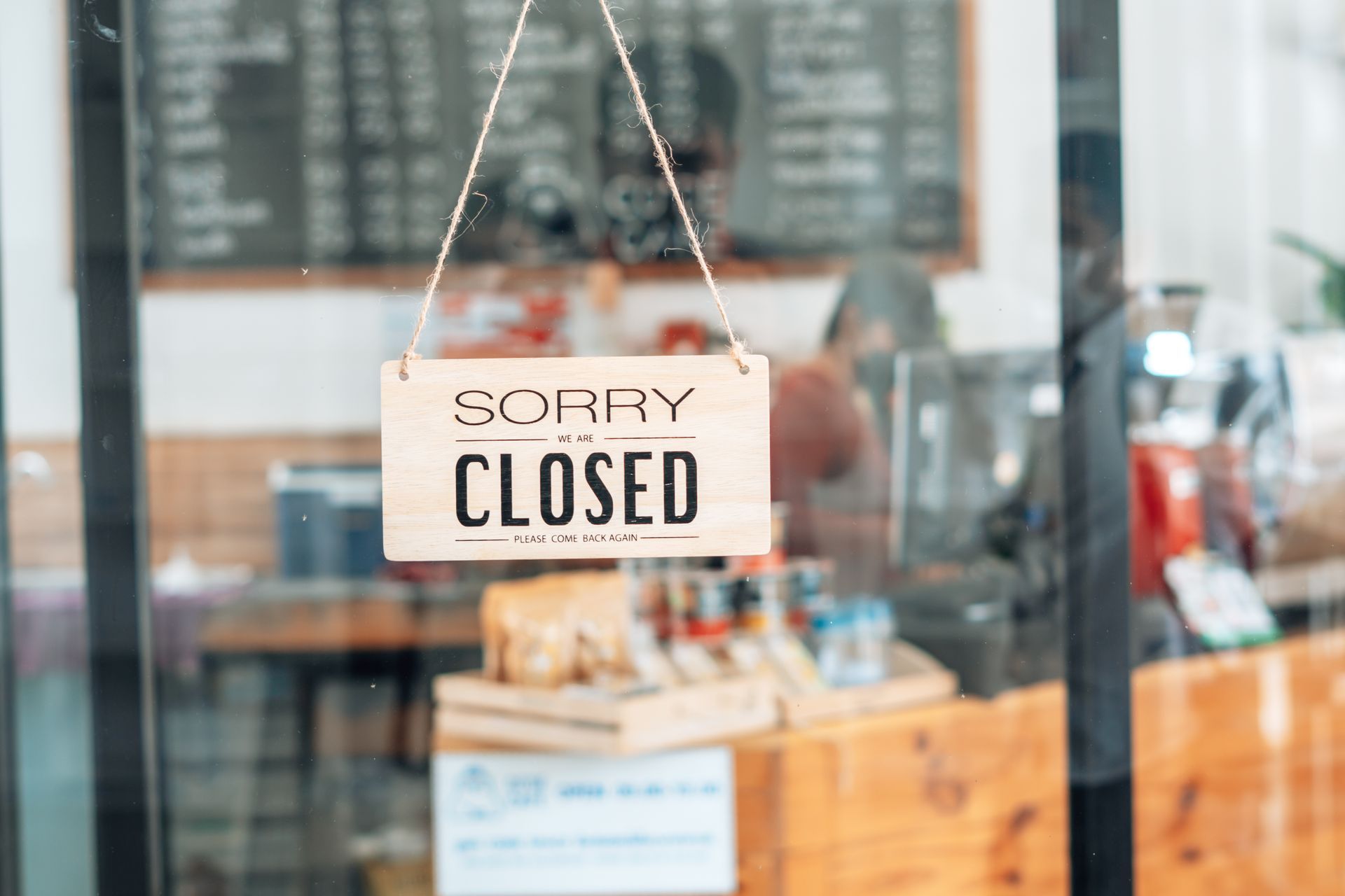 A family is moving into a new home carrying boxes.