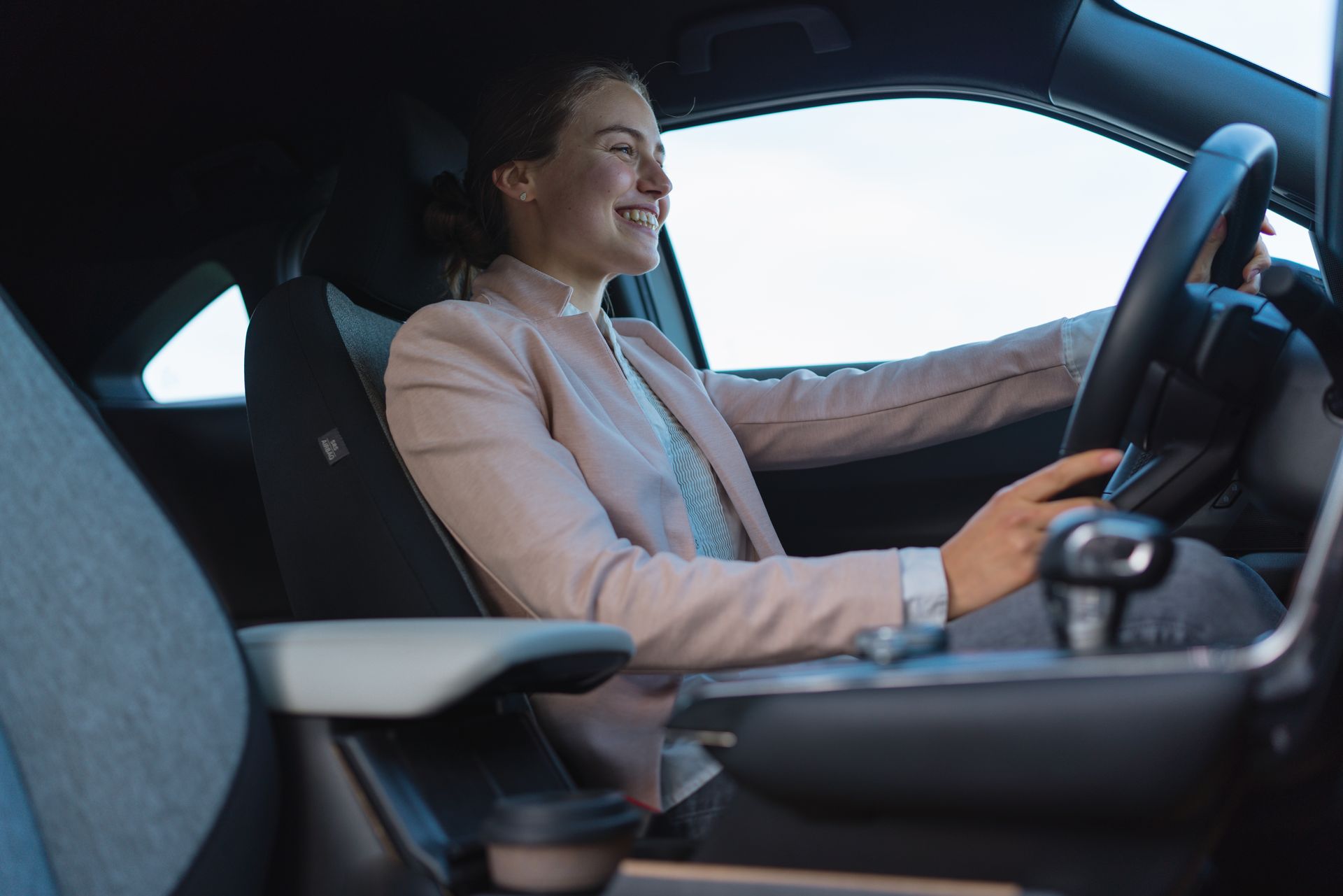 A family is moving into a new home carrying boxes.