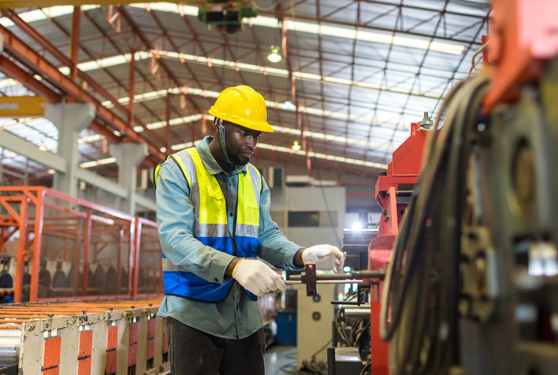 Two men are standing in a kitchen talking to each other.