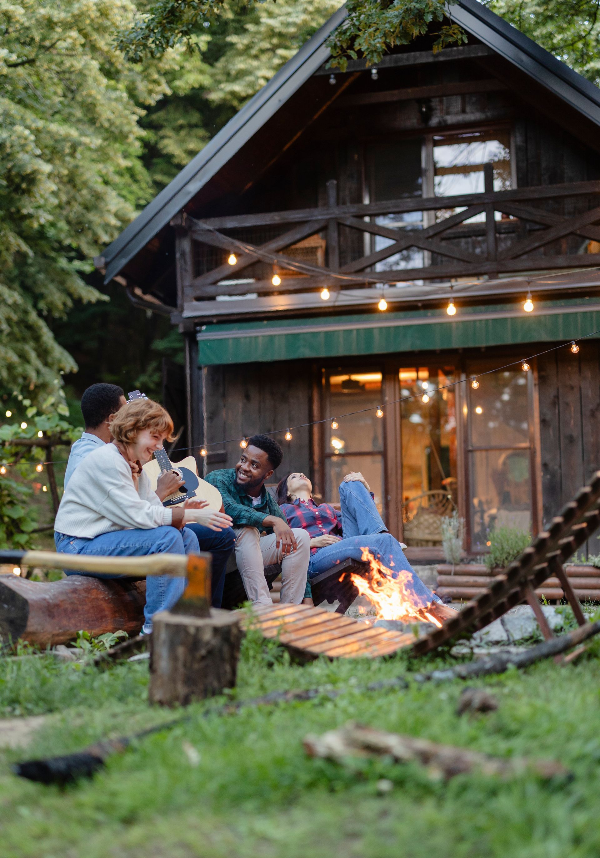 A man and a woman are sitting on a couch in a living room watching tv.