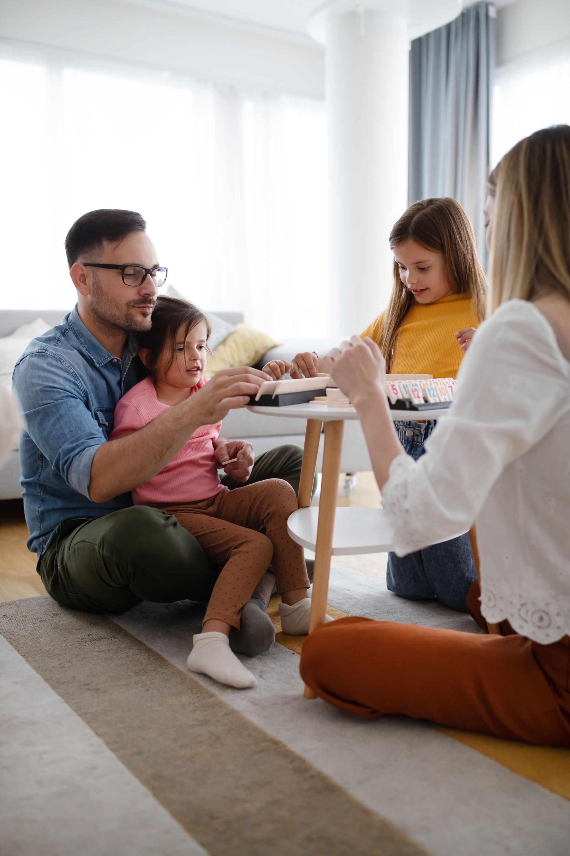 A family is standing in front of a door in a hallway.