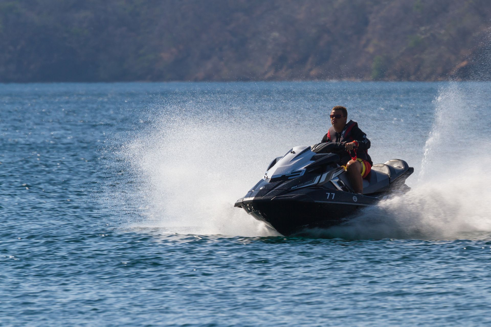 A family is standing in front of a door in a hallway.
