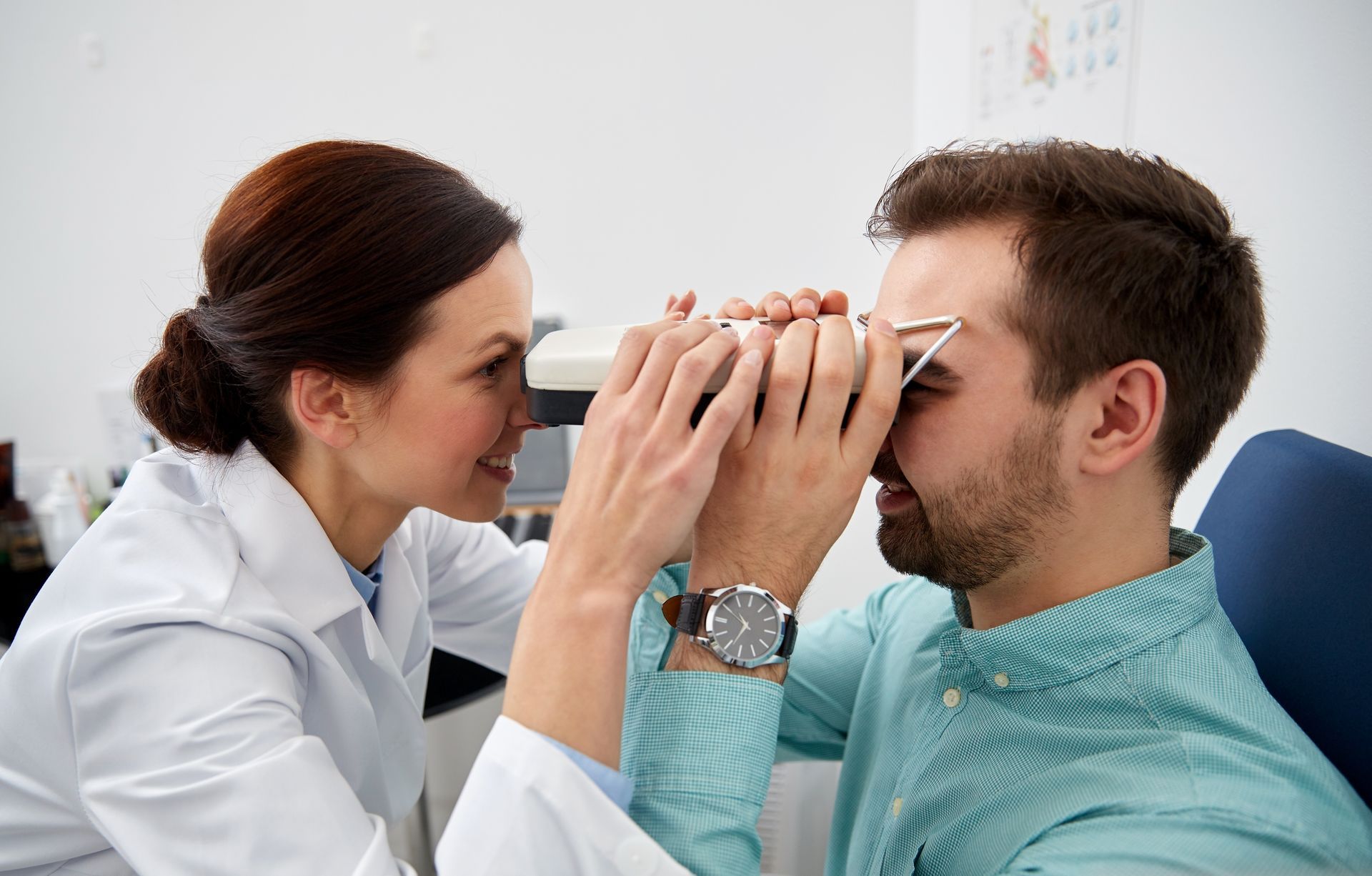 Two men are standing in a kitchen talking to each other.