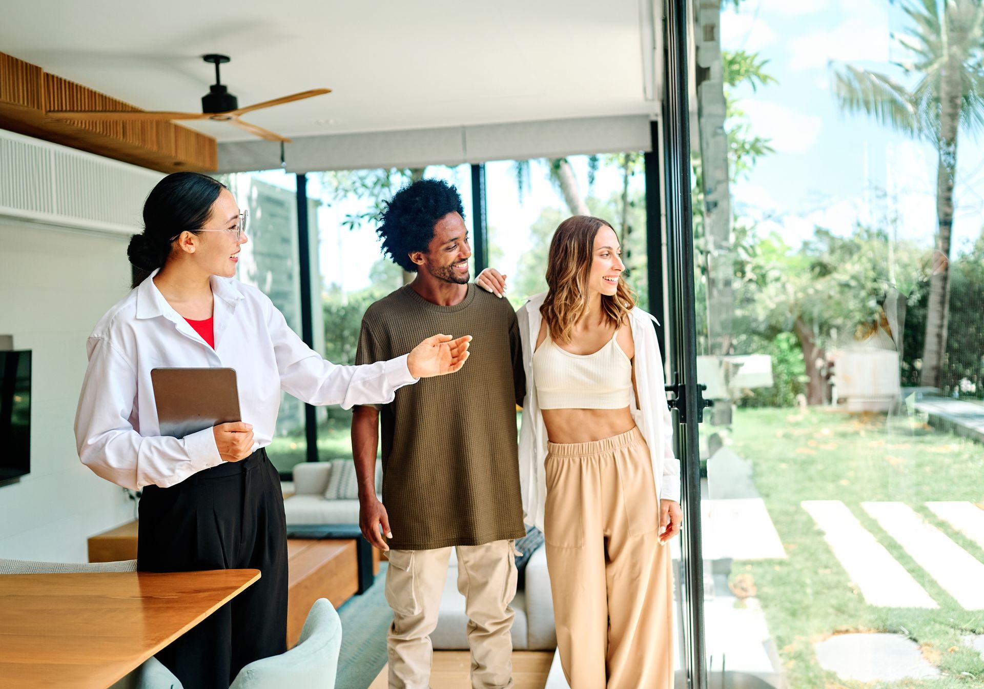 Two men are standing in a kitchen talking to each other.