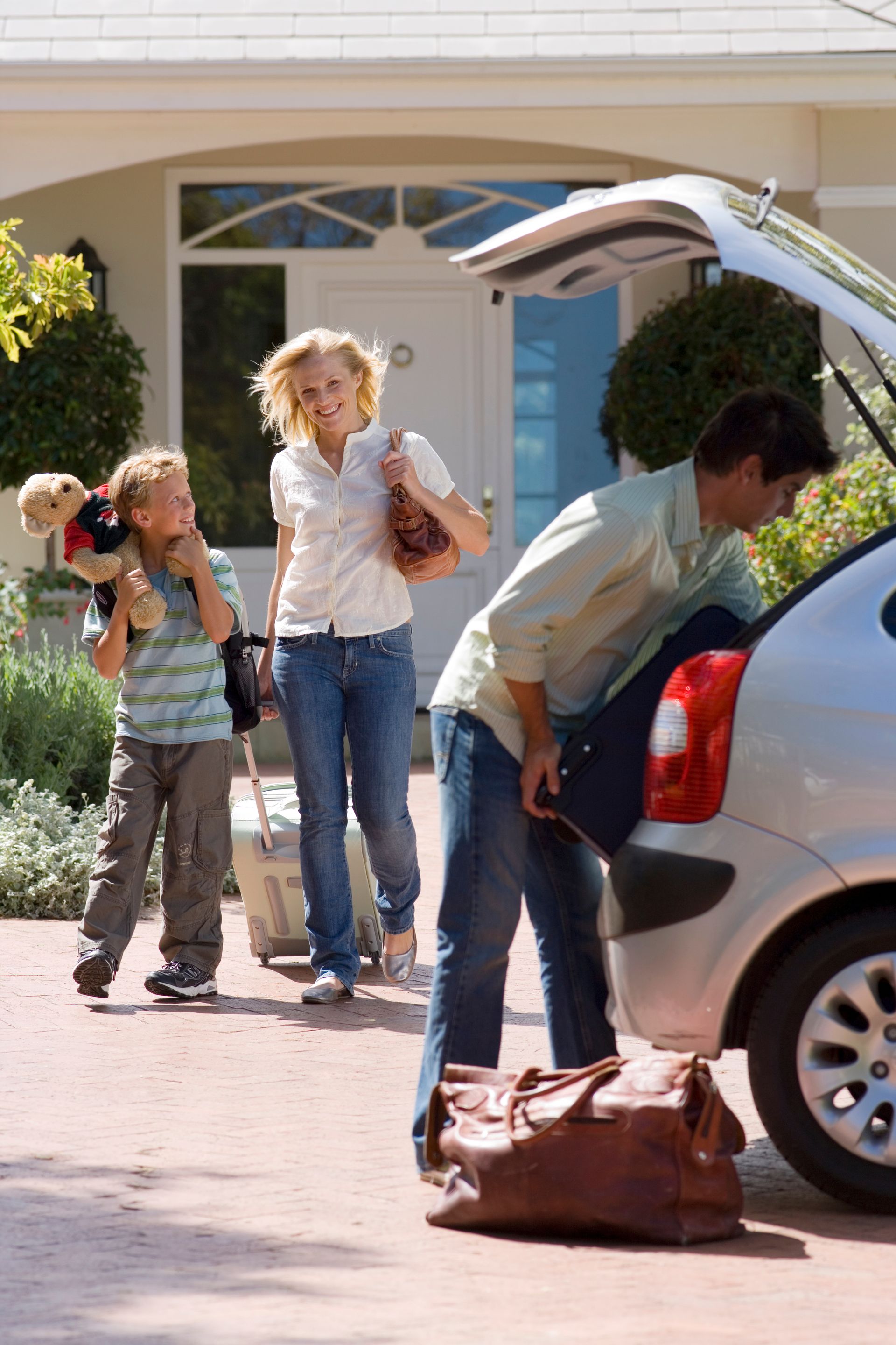 A man and a woman are sitting on a couch in a living room watching tv.