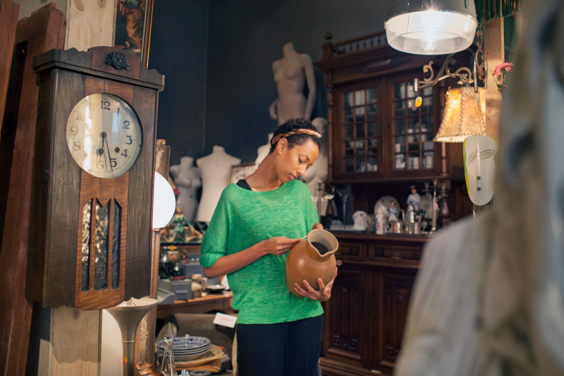 A man and a woman are sitting on a couch in a living room watching tv.
