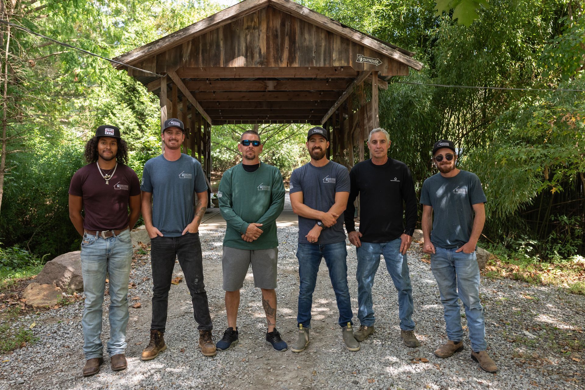 Construction worker on scaffolding, building a multi-story house on a sunny day.