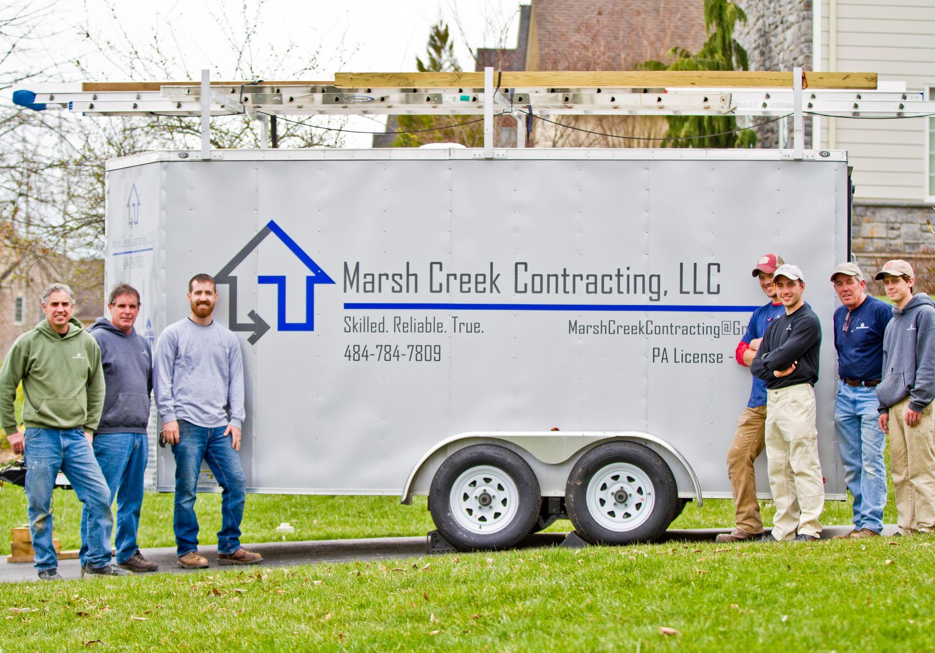 Marsh Creek Contracting team poses by their trailer.