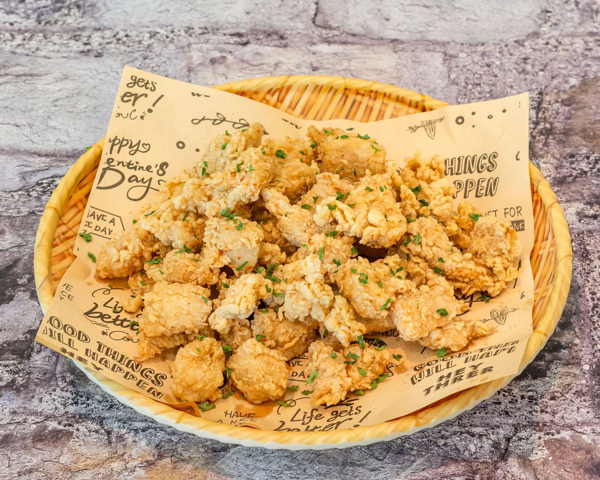 Poke Go's pop corn chicken in a bamboo pan on table