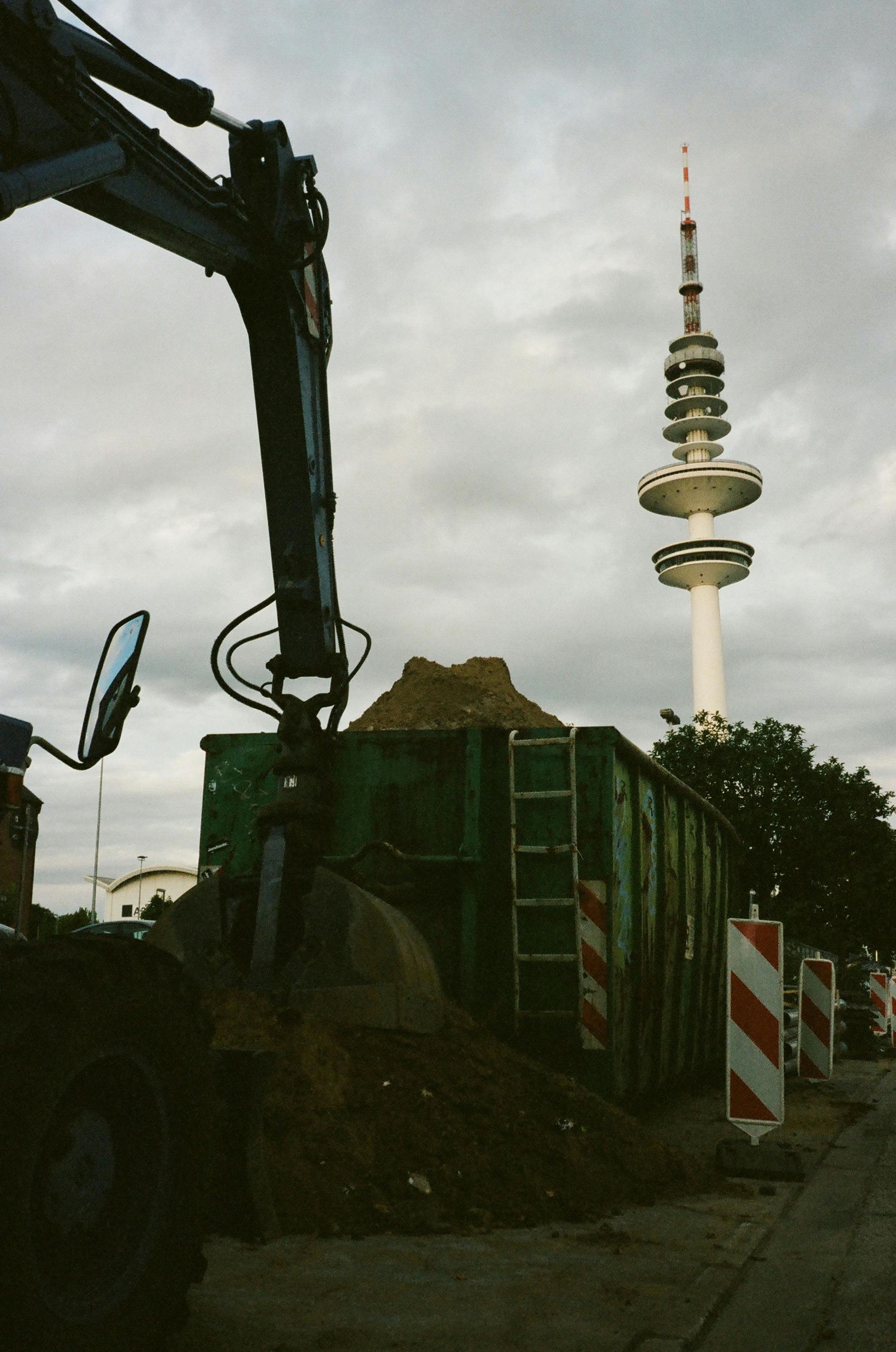 A construction site with a tower in the background