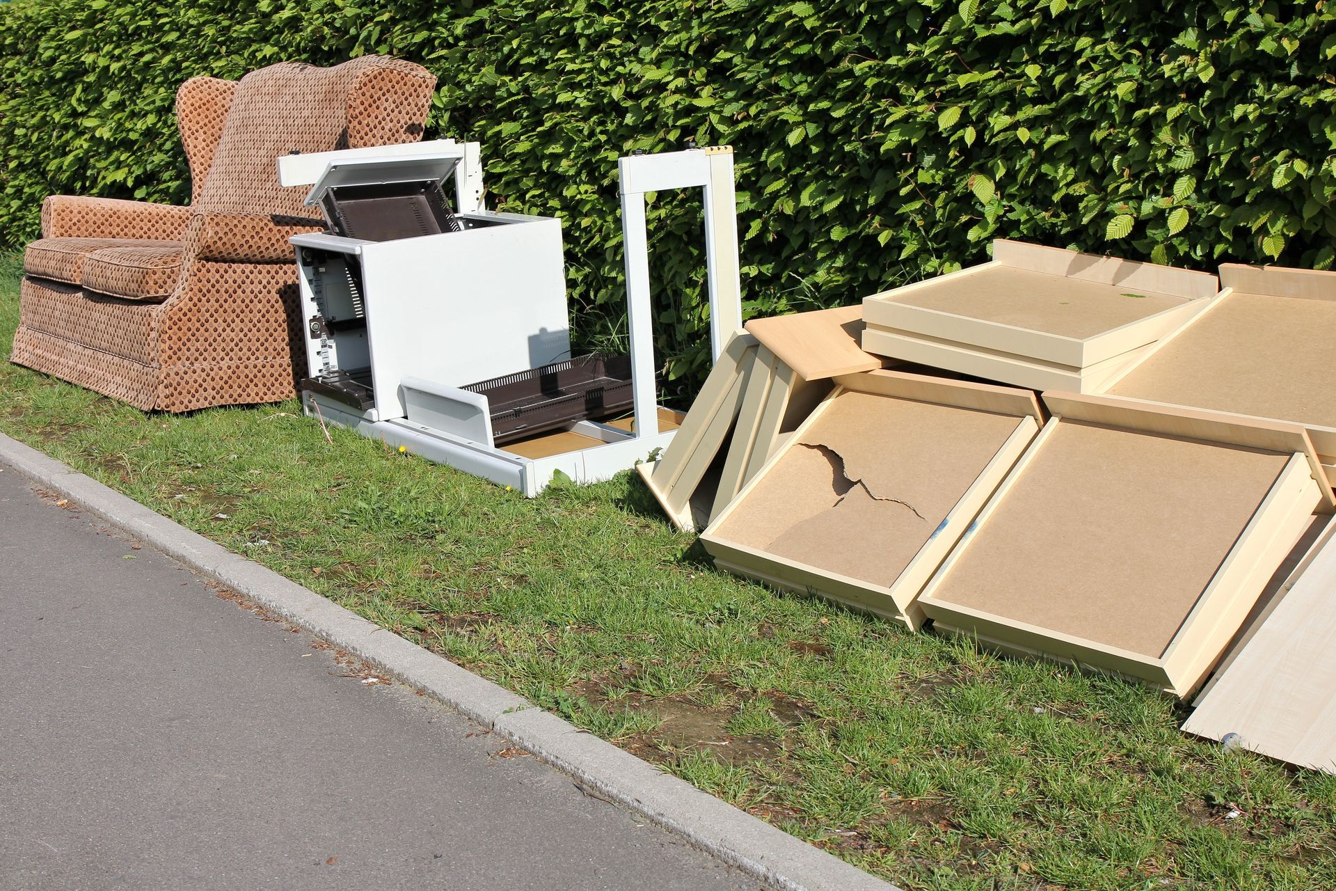A pile of junk is sitting on the side of the road.