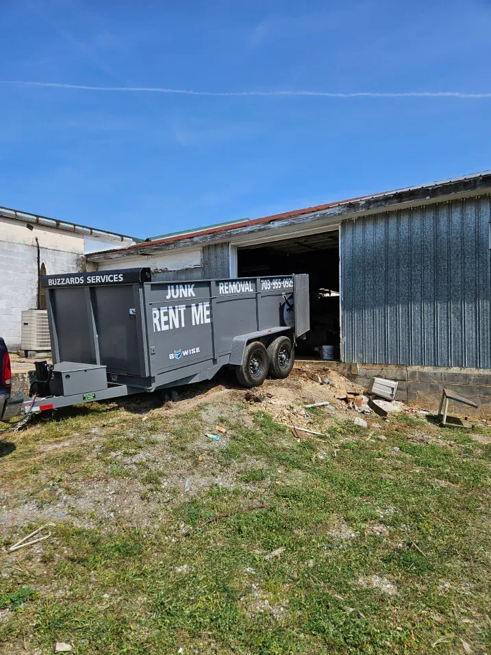 A gray dumpster trailer labeled 