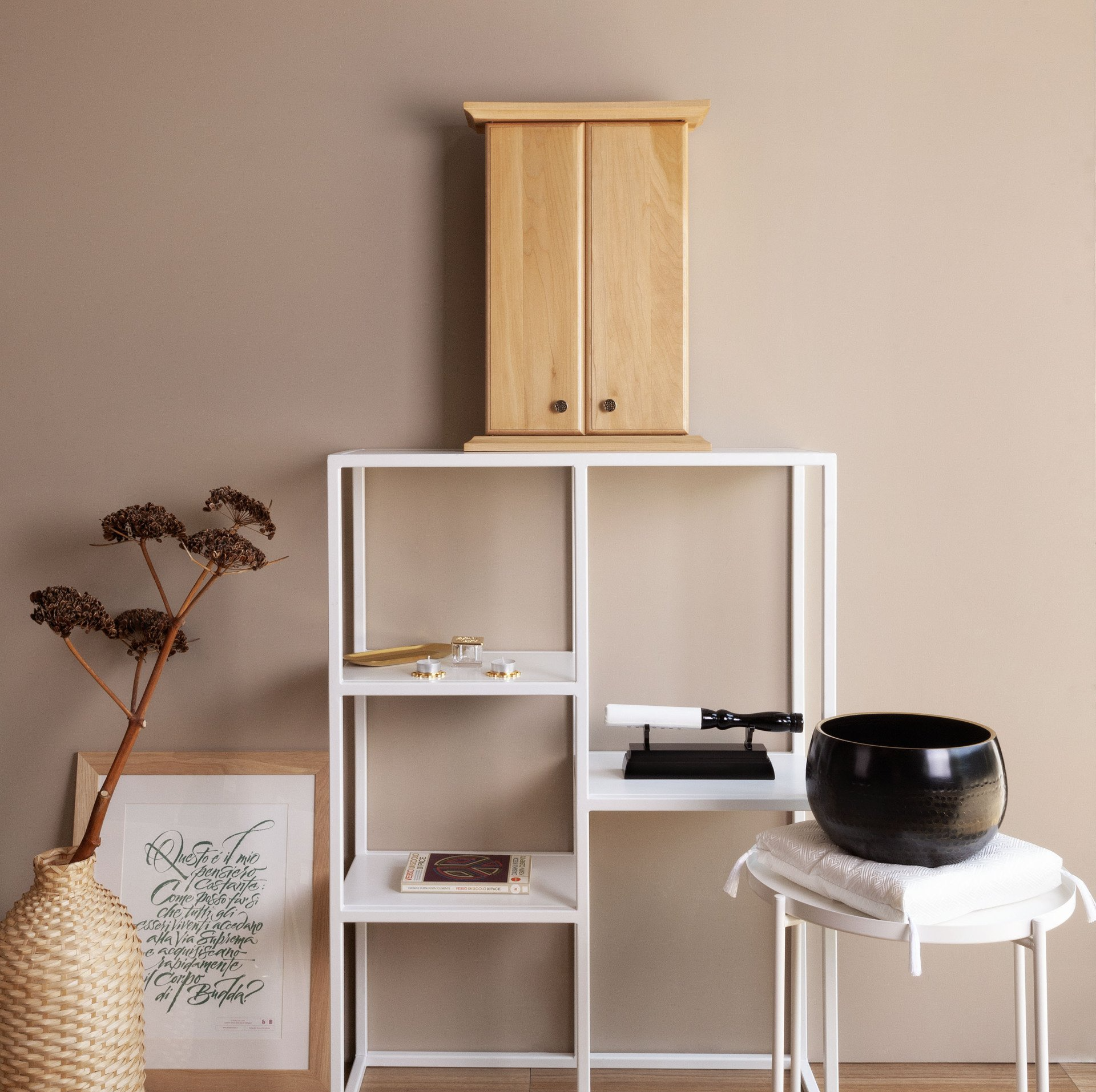 Uno scaffale bianco con un butsudan di legno sopra