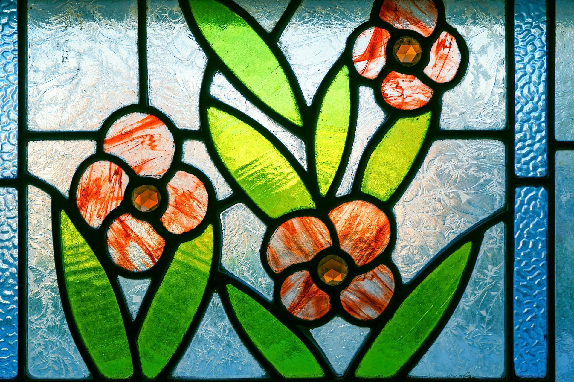 A stained glass window shows jesus and two angels in a boat