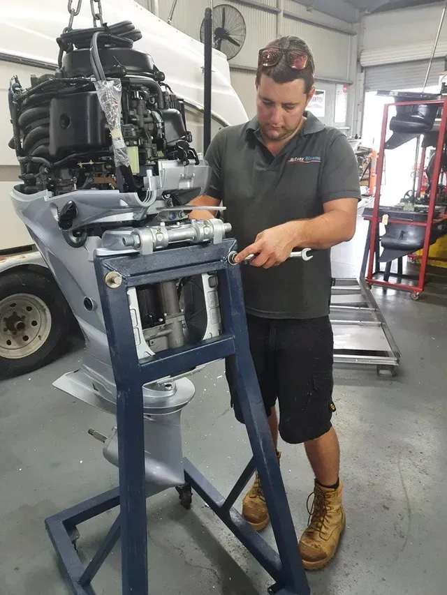 Mechanic Working on An Outboard Motor in A Workshop — HiTune Marine In Bentley Park, QLD 