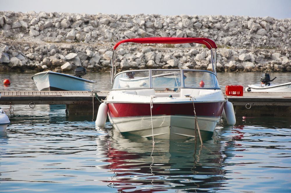 Red and White Motorboat Docked at A Harbor, Red Awning, Small Boats in Background — HiTune Marine In Mossman, QLD 