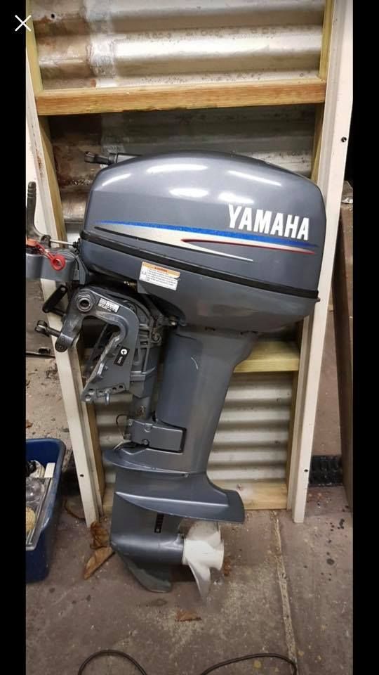Yamaha Outboard Motor, Gray and Blue, Mounted on A Wooden Frame, in A Workshop — HiTune Marine In Mareeba, QLD