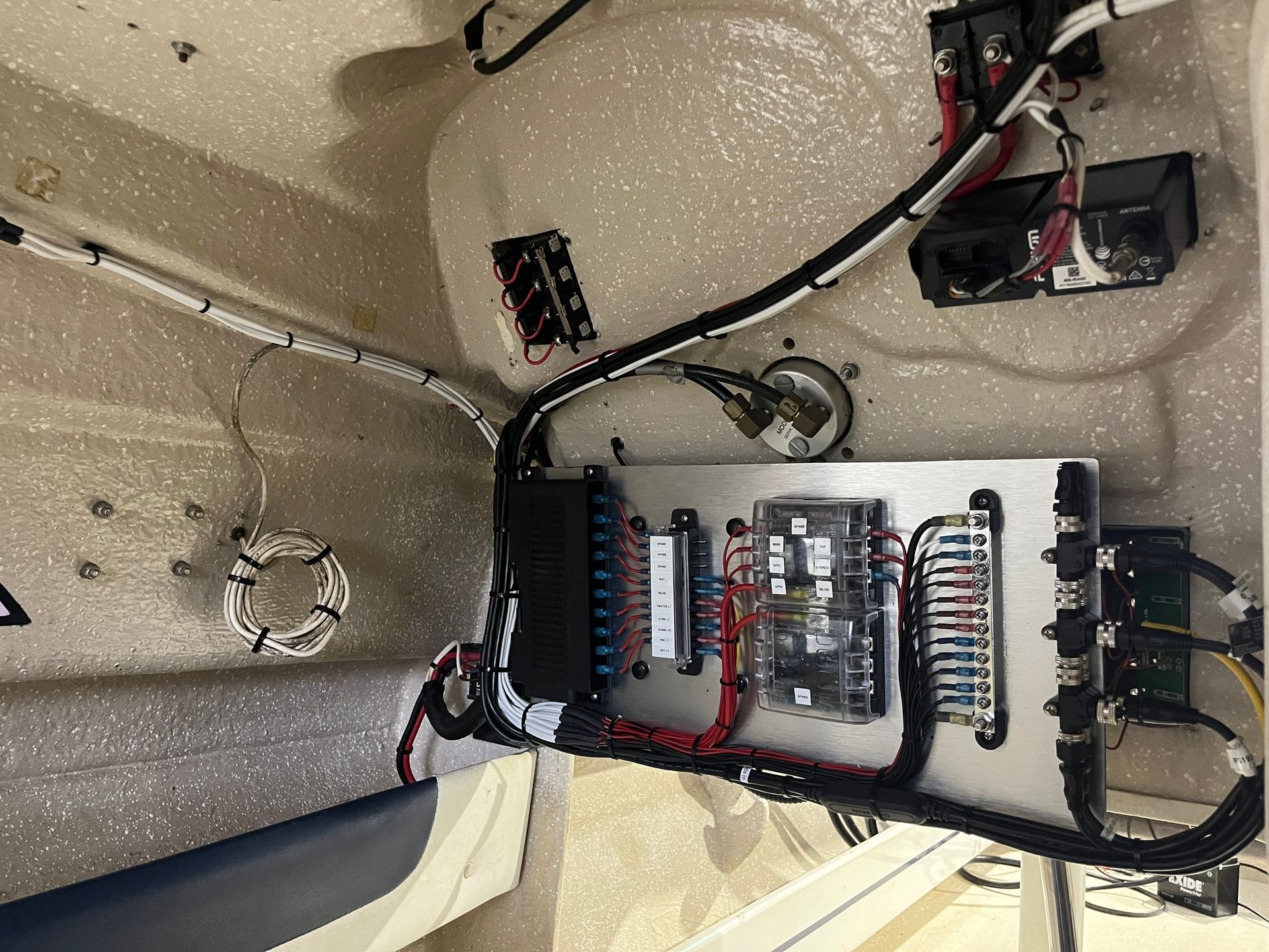 Boat's Electrical Panel with Wires, Fuses, and Connectors Inside a White Compartment — HiTune Marine In Atherton, QLD 