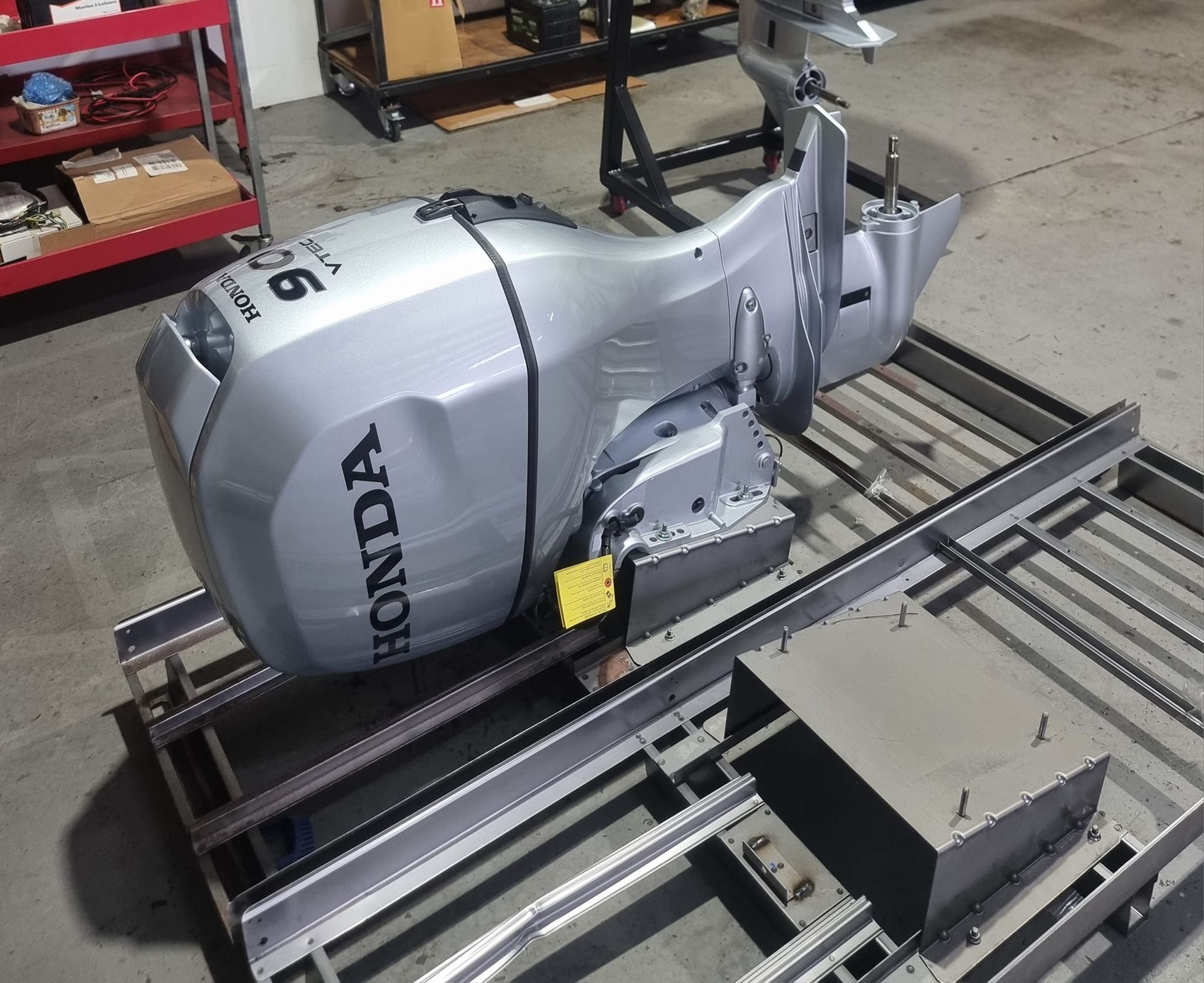 A Silver Honda Outboard Motor on A Metal Frame in A Workshop — HiTune Marine In Innisfail, QLD 