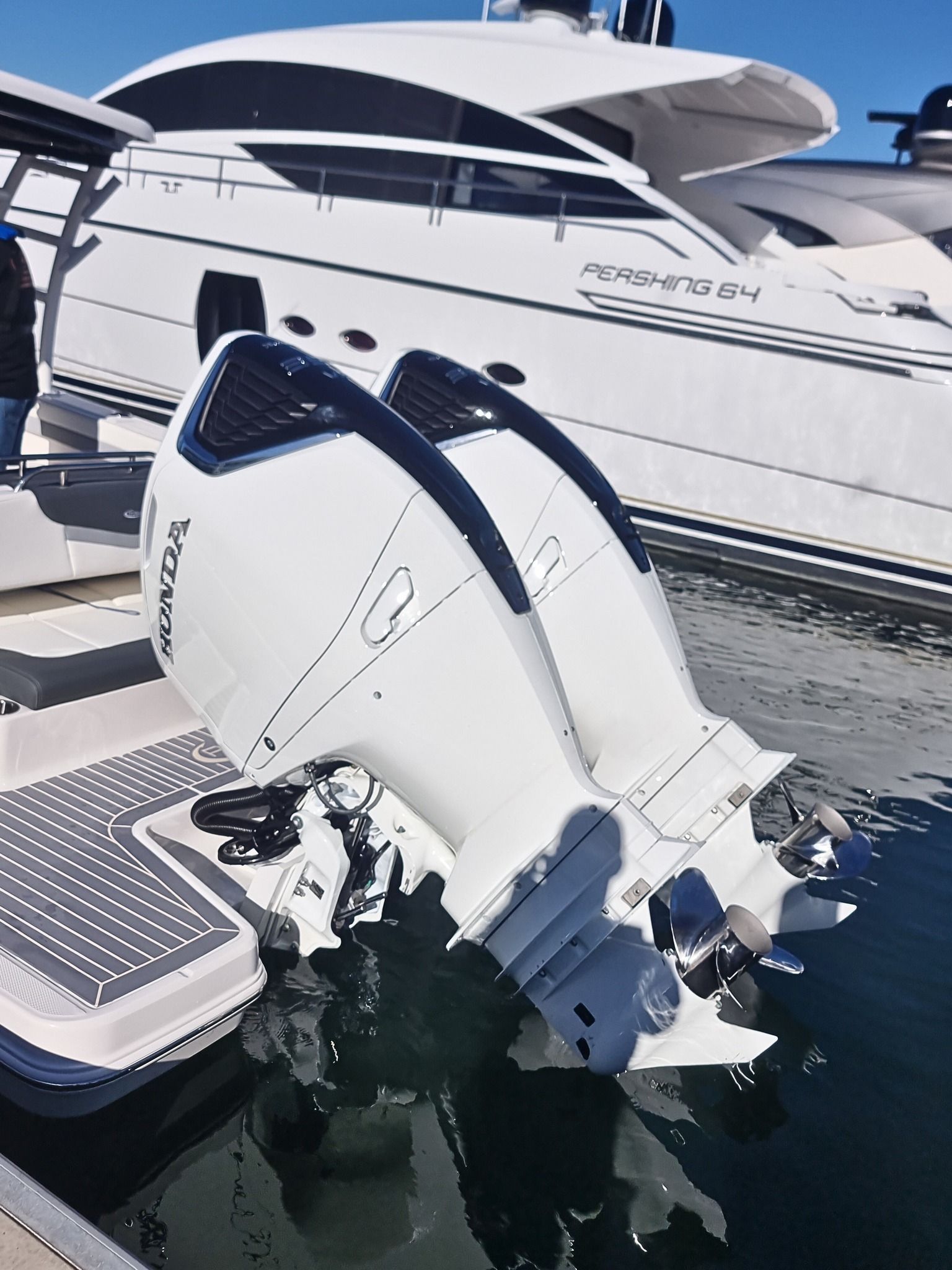 Two White Honda Boat Engines Attached to A Boat, with A Large Yacht in The Background — HiTune Marine In Mareeba, QLD