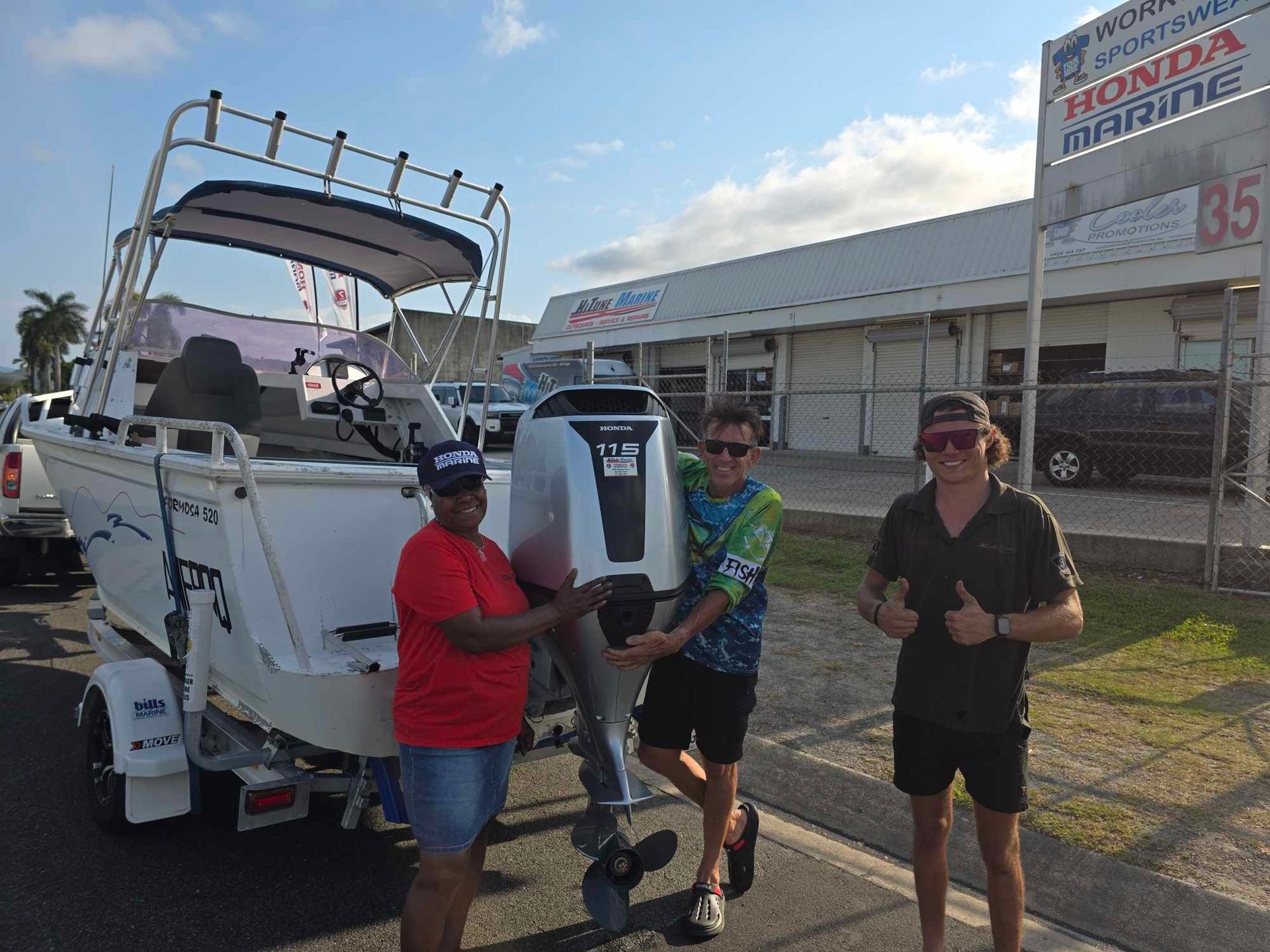 Three People with A New Boat and Outboard Motor in Front of A Honda Marine Store — HiTune Marine In Bentley Park, QLD 