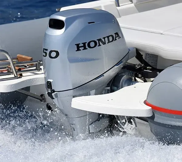 Honda 50 Outboard Motor on A White Boat, Generating Splashing Water in A Sunny Setting — HiTune Marine In Bentley Park, QLD