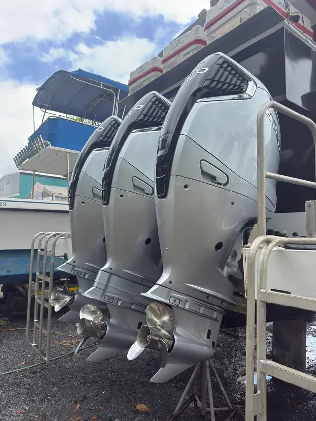 Three Large Silver Outboard Boat Motors with Propellers, Lined up On a Boat's Transom, Outside — HiTune Marine In Bentley Park, QLD 