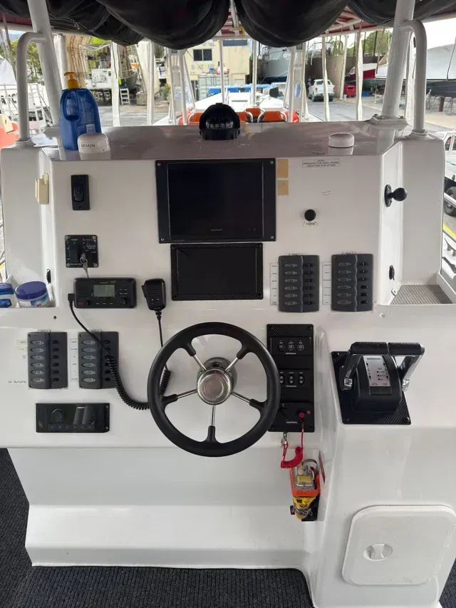 Boat Dashboard with Navigation Screens, Steering Wheel, and Control Switches — HiTune Marine In Bentley Park, QLD 