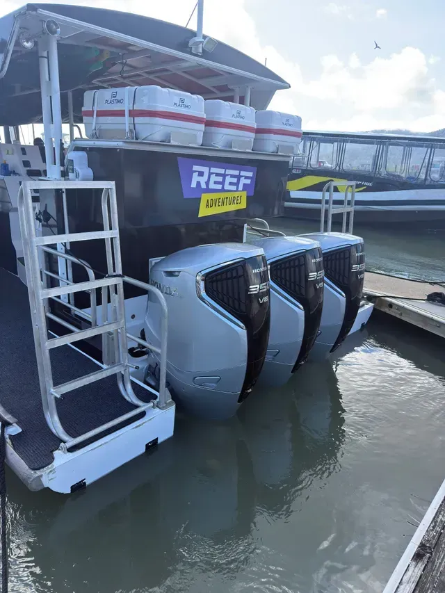 A Boat with Three Large Outboard Motors, Docked at A Pier — HiTune Marine In Bentley Park, QLD 