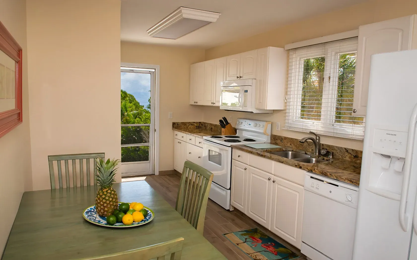 A kitchen with a table and chairs and a pineapple on the table