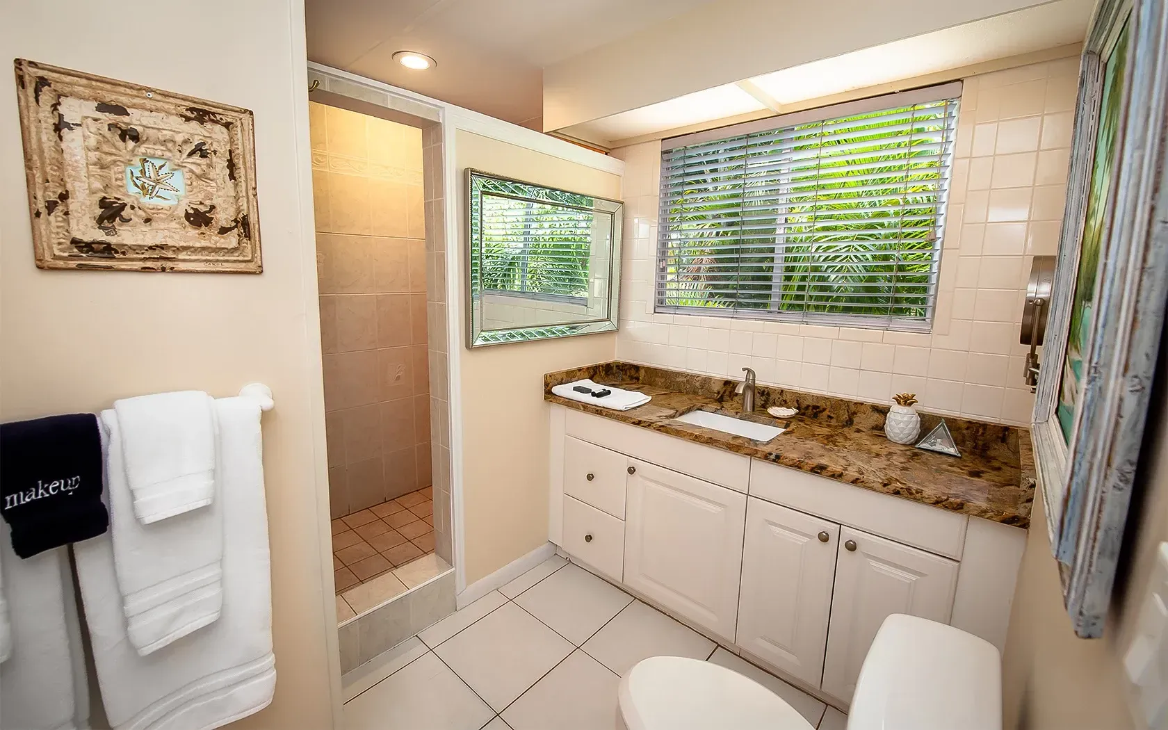 A bathroom with a toilet , sink , and shower.