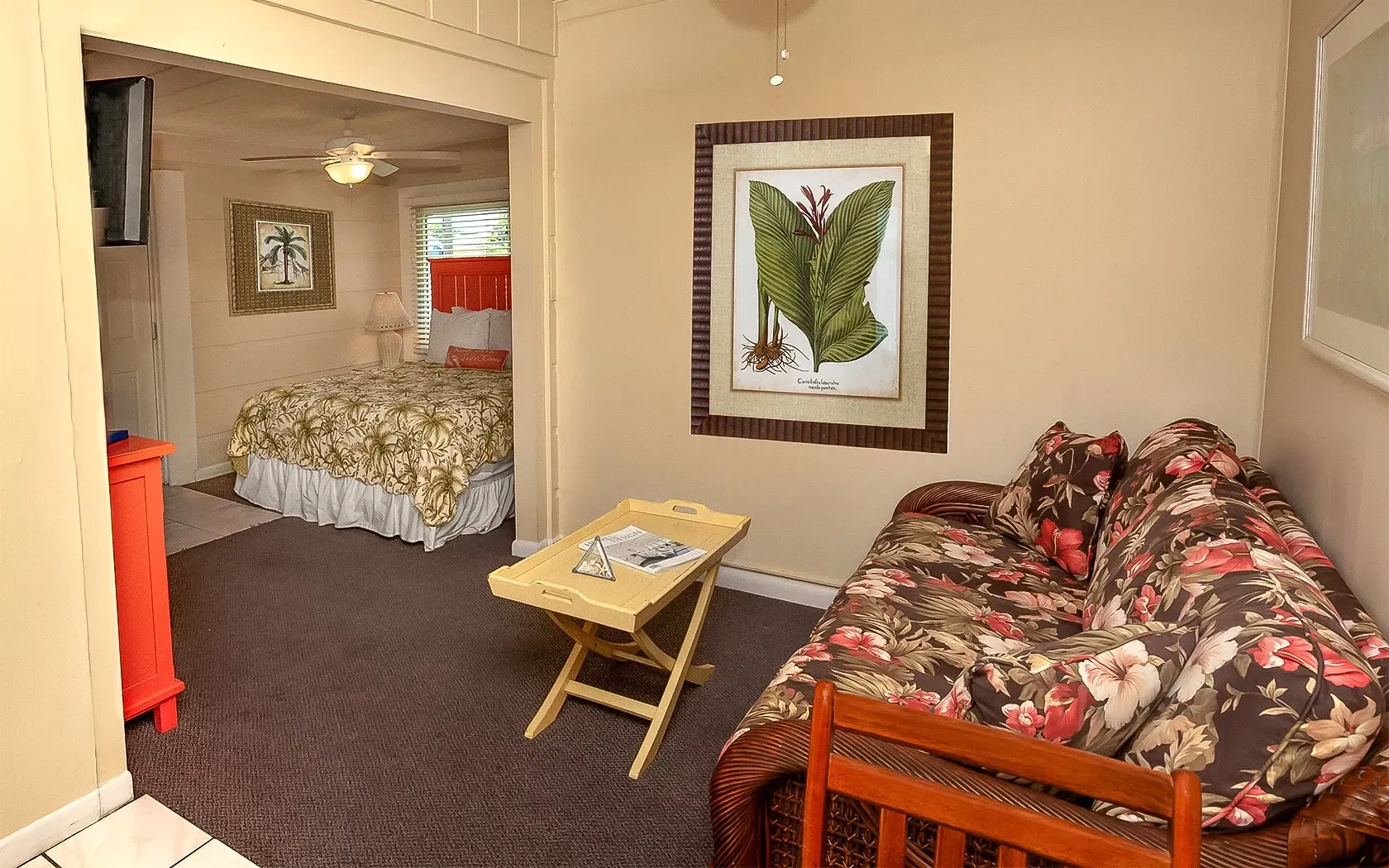 A living room with a couch and a picture on the wall