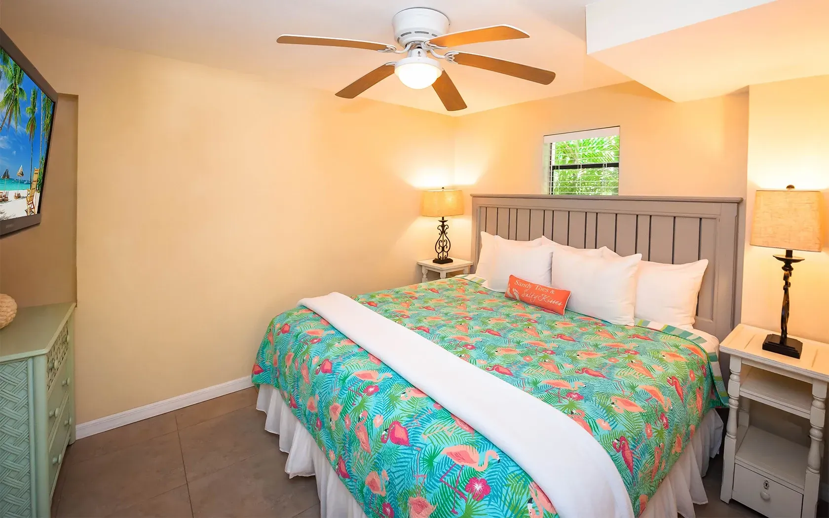 A bedroom with a king size bed and a flat screen tv.