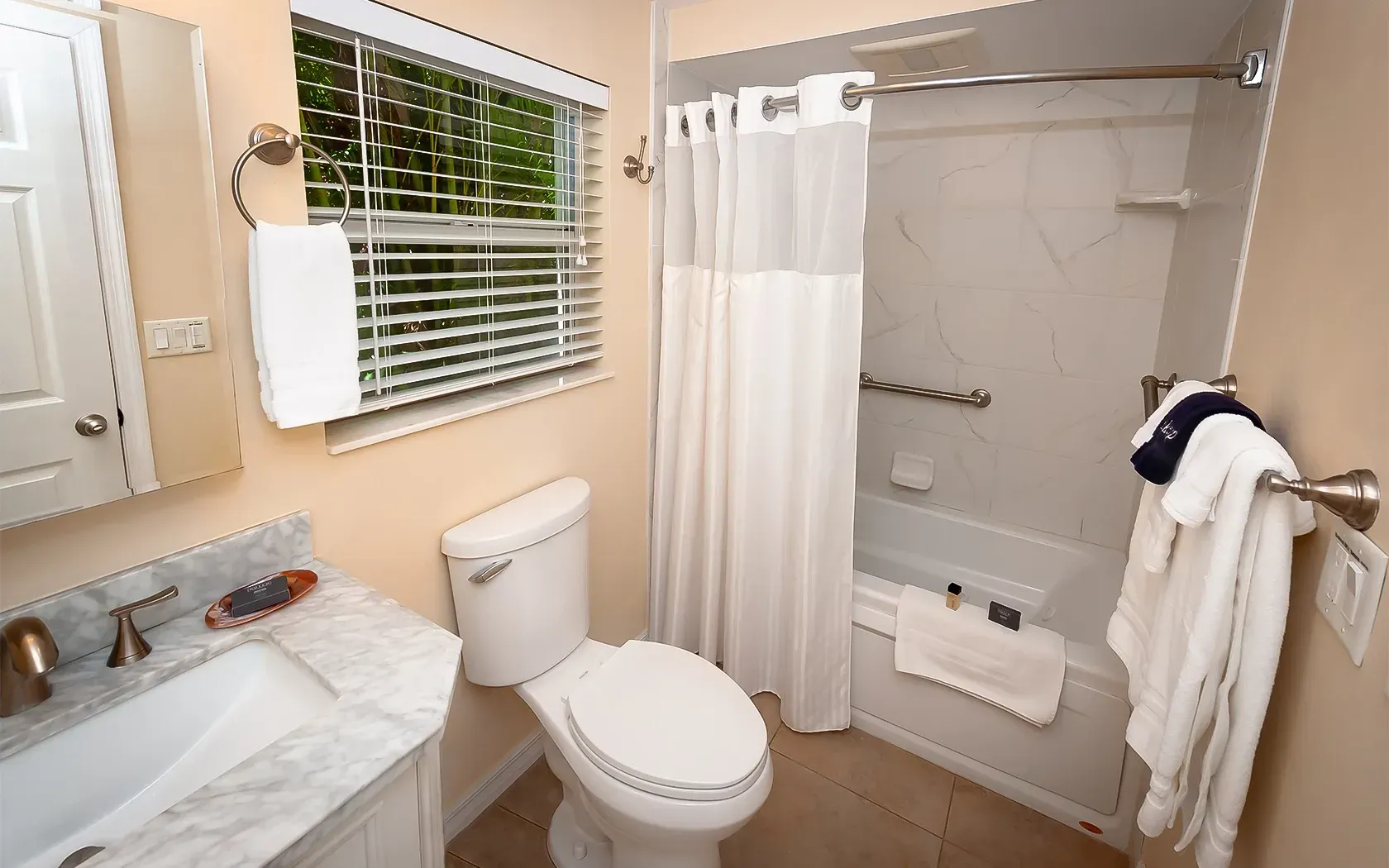 A bathroom with a toilet a sink and a bathtub