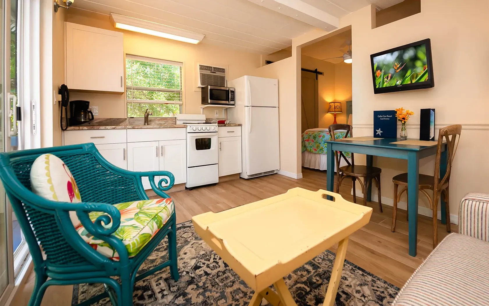 A living room with a chair , table , and television.