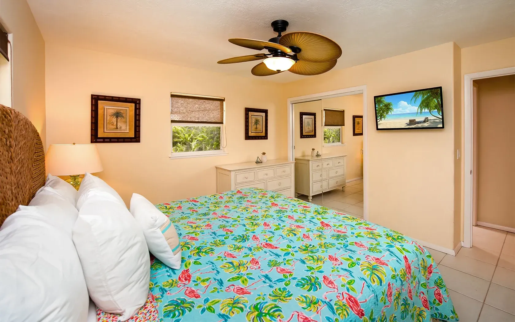 A bedroom with a bed and a ceiling fan