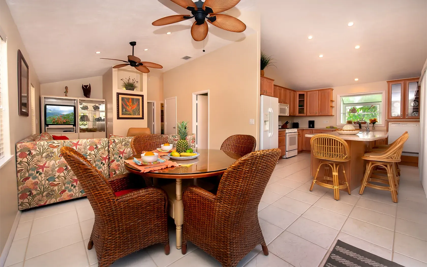 A living room with a table and chairs and a ceiling fan