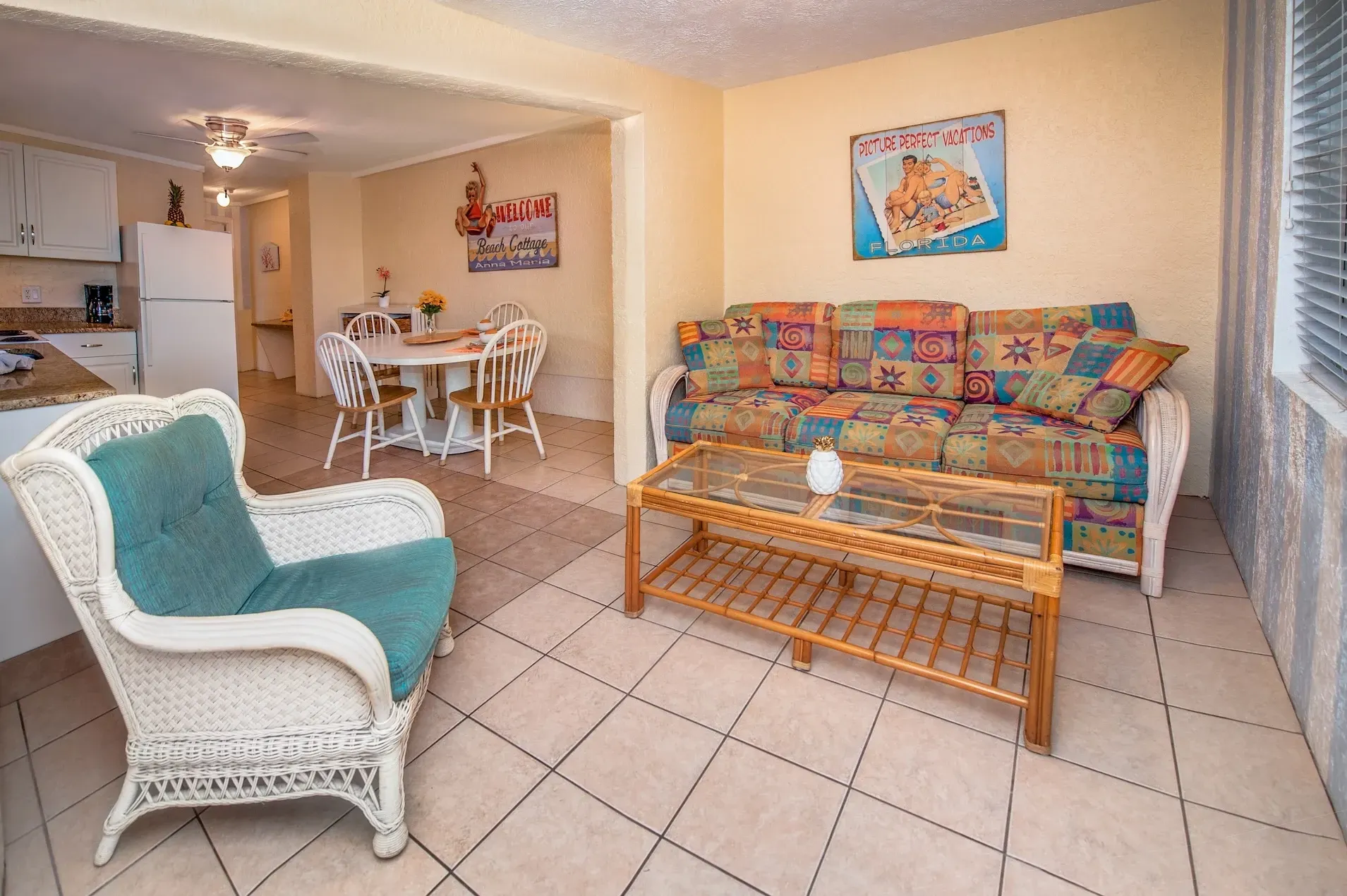 A living room with a couch , chair , table and coffee table.