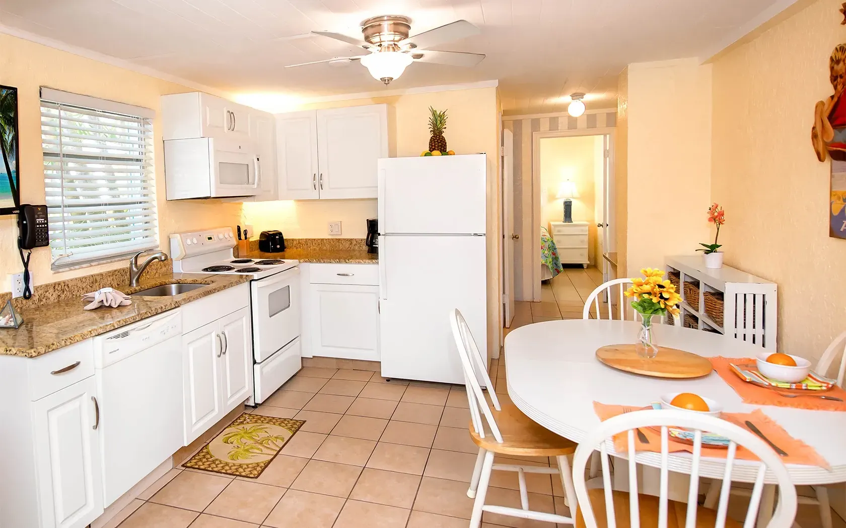 A kitchen with a table and chairs and a refrigerator