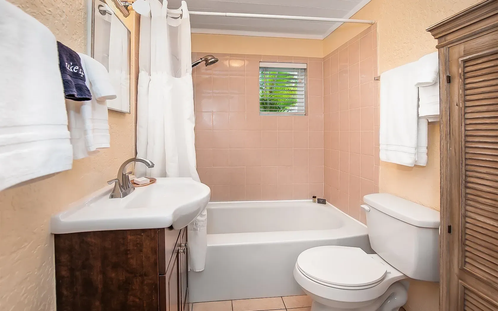 A bathroom with a sink , toilet , tub and shower.