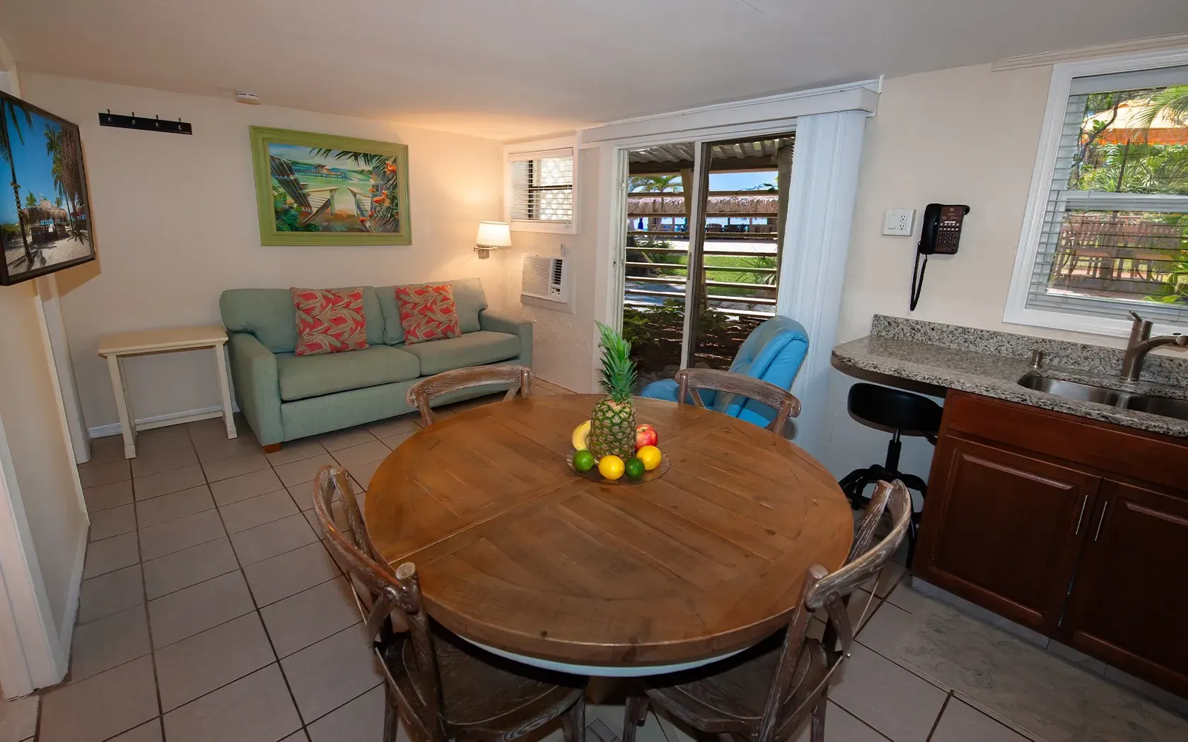 A living room with a table and chairs and a couch.