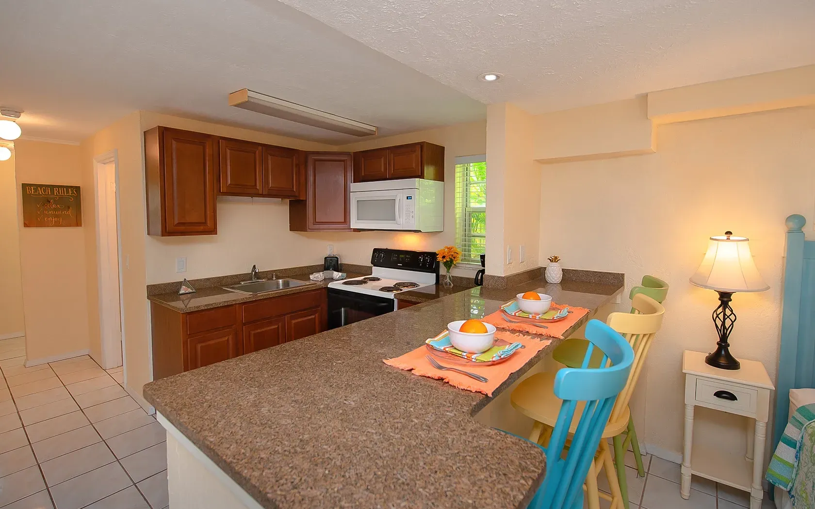 A kitchen with granite counter tops and wooden cabinets