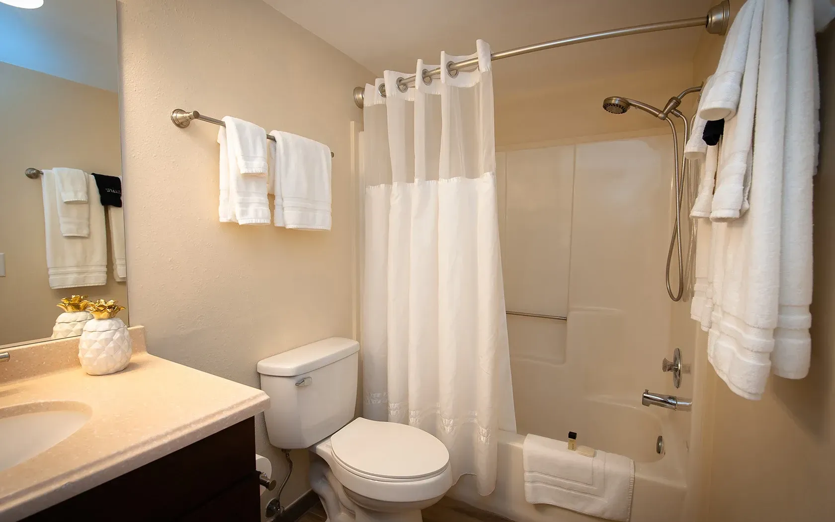 A bathroom with a toilet , sink , shower and bathtub.