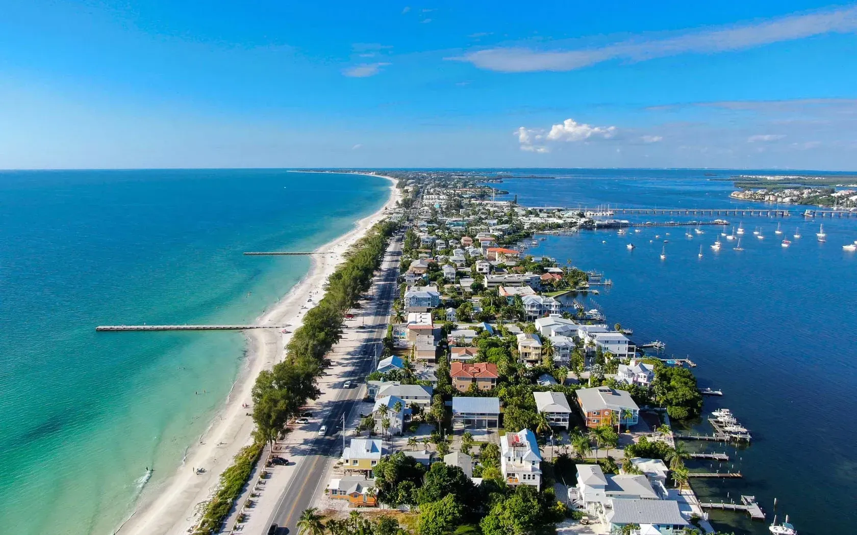 An aerial view of a small town next to the ocean.